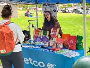 Petco representative speaking with customers at bark in the park
