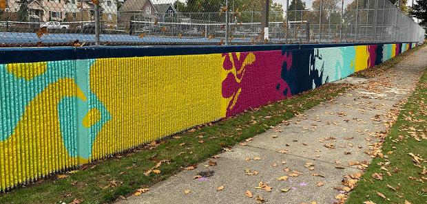 Brightly painted tennis court wall in Clark Park